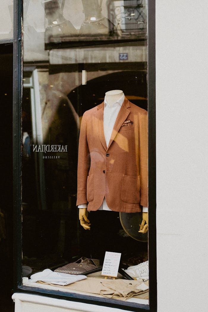 Sophisticated men's suit showcased on a mannequin in a boutique window display.